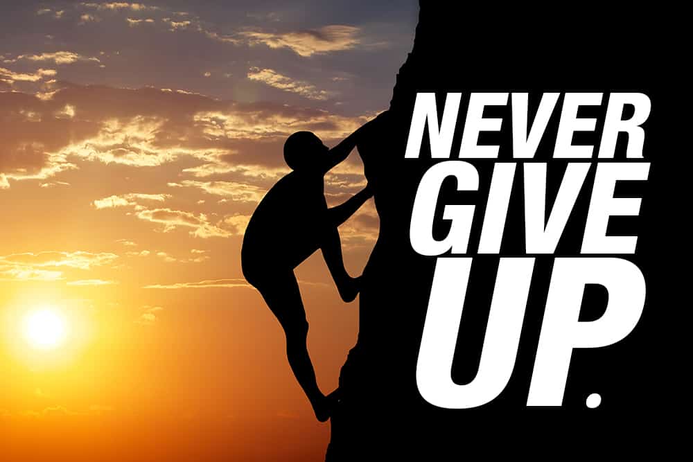 In pursuit of his new year's resolution, a determined man sticks with the climb up a challenging cliff, reminding himself to never give up.