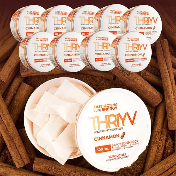 THRYV Cinnamon nootropic pouches with packaging on a wooden surface with cinnamon sticks.