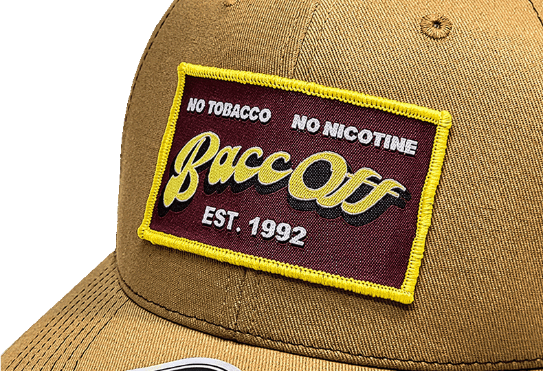 BaccOff Est. 1992 embroidered patch closeup on tan trucker hat, no tobacco no nicotine
